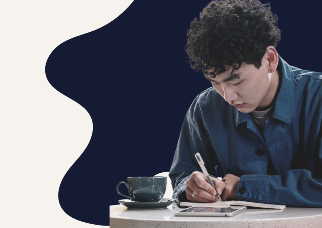 Person signing a document by hand with a pen